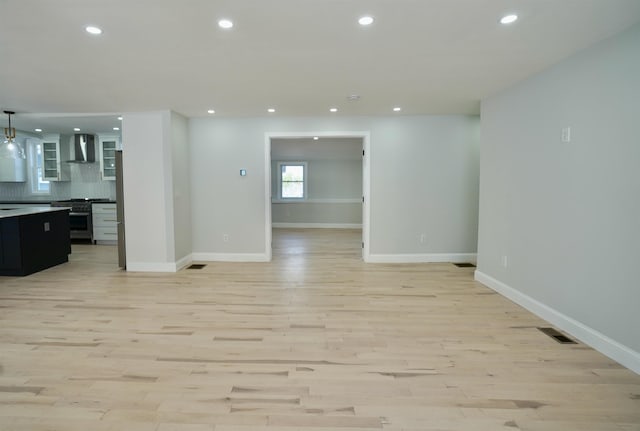 empty room featuring baseboards, recessed lighting, and light wood-style flooring