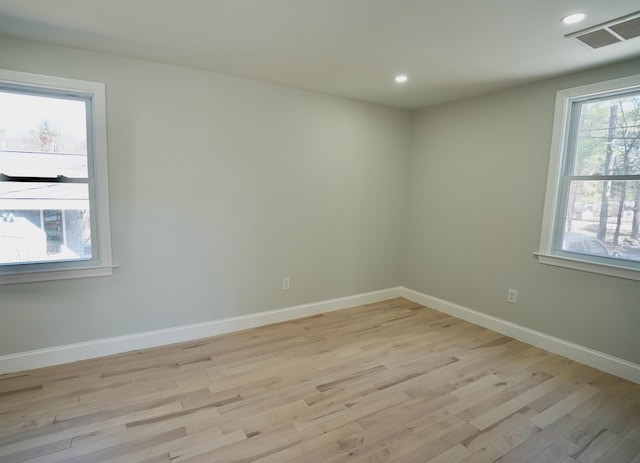 empty room with recessed lighting, baseboards, visible vents, and light wood-style floors