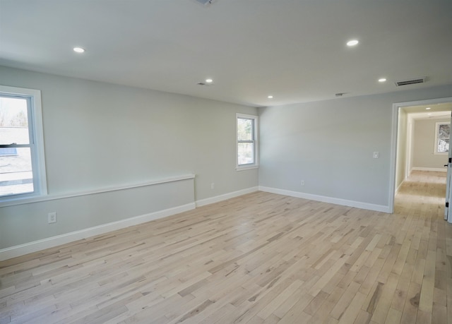 spare room featuring visible vents, recessed lighting, light wood-style flooring, and baseboards