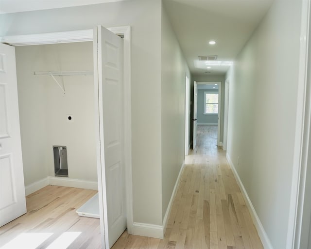 corridor with light wood-type flooring, recessed lighting, baseboards, and visible vents