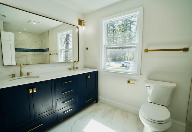 full bath with plenty of natural light, a sink, and toilet