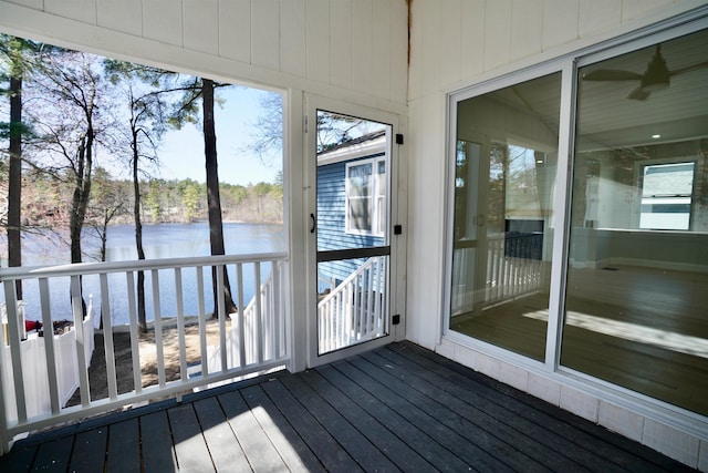 unfurnished sunroom featuring a water view