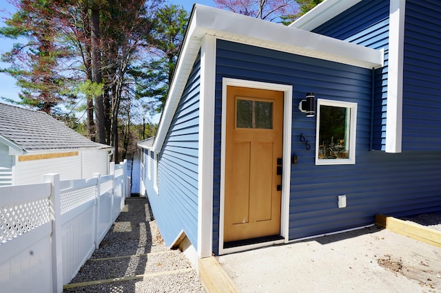 doorway to property featuring fence