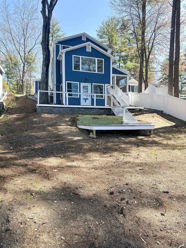rear view of property with fence