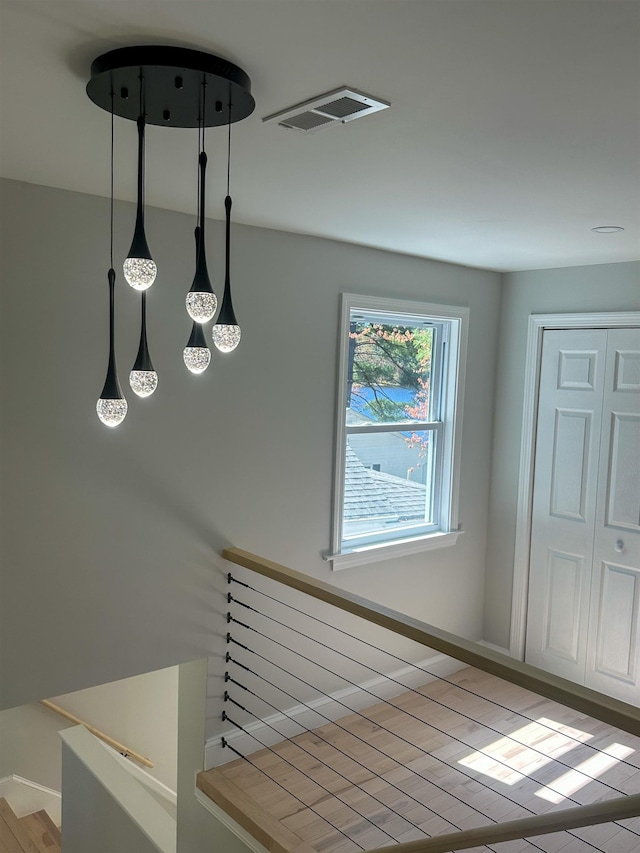 stairway featuring visible vents