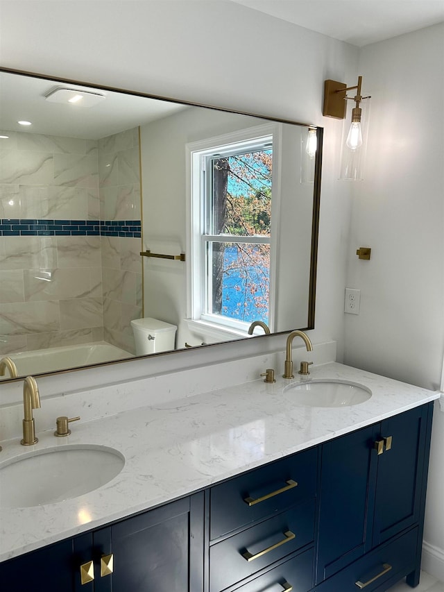 bathroom with double vanity, a sink, walk in shower, and a washtub