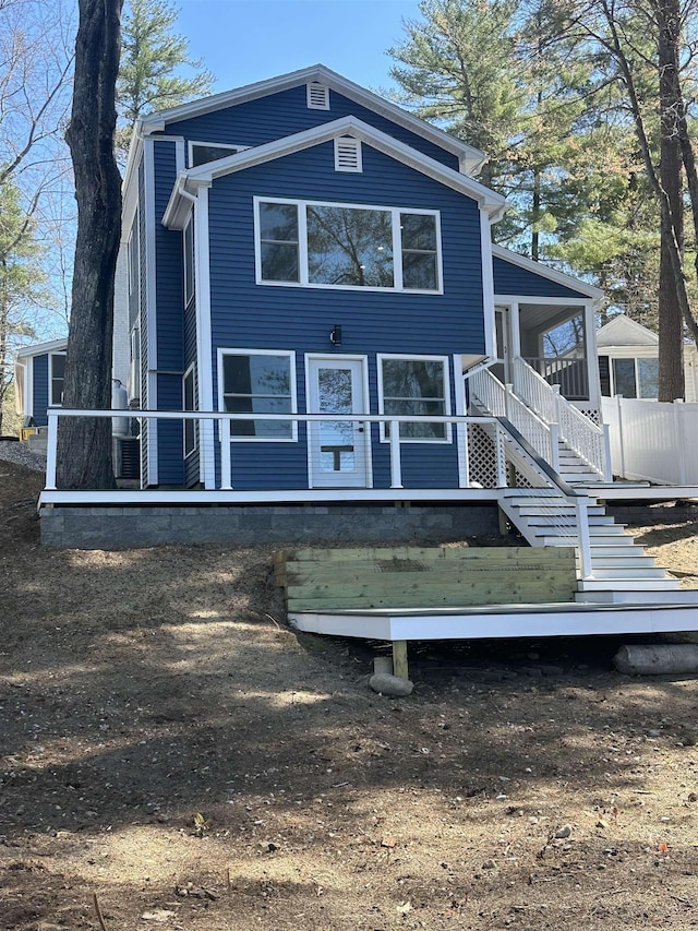 back of house featuring stairs