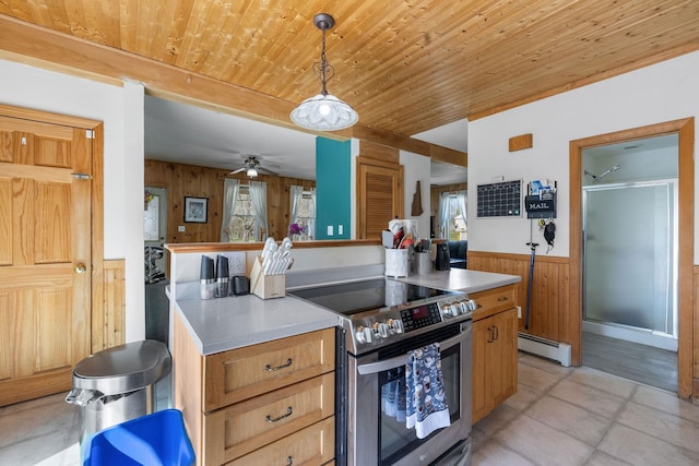 kitchen featuring wooden walls, stainless steel electric range, wainscoting, wooden ceiling, and a baseboard radiator