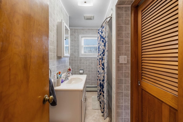 full bathroom featuring tile walls, tile patterned flooring, baseboard heating, vanity, and a shower with shower curtain
