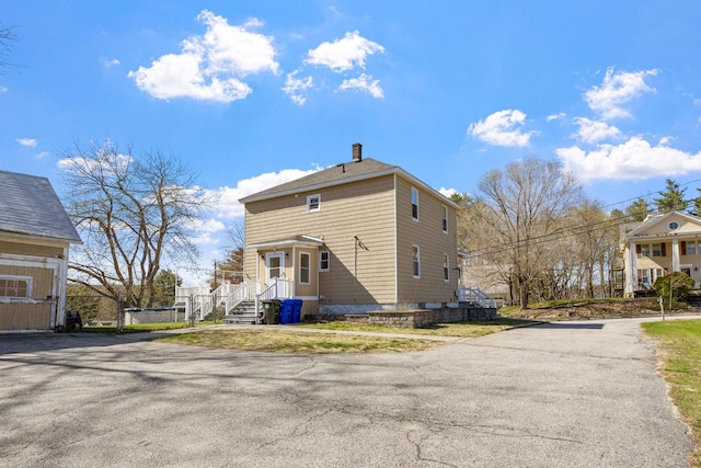 view of property exterior featuring a chimney
