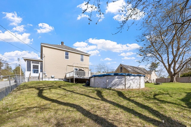 rear view of house with a lawn, a fenced backyard, a fenced in pool, and entry steps
