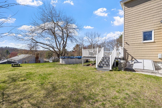 view of yard featuring a covered pool and a deck