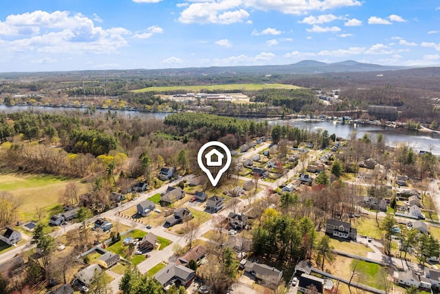 aerial view with a residential view, a water and mountain view, and a forest view