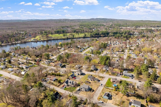 aerial view with a wooded view, a water view, and a residential view
