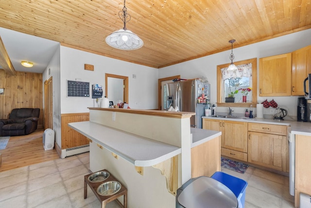 kitchen with stainless steel fridge, wooden ceiling, baseboard heating, and wood walls