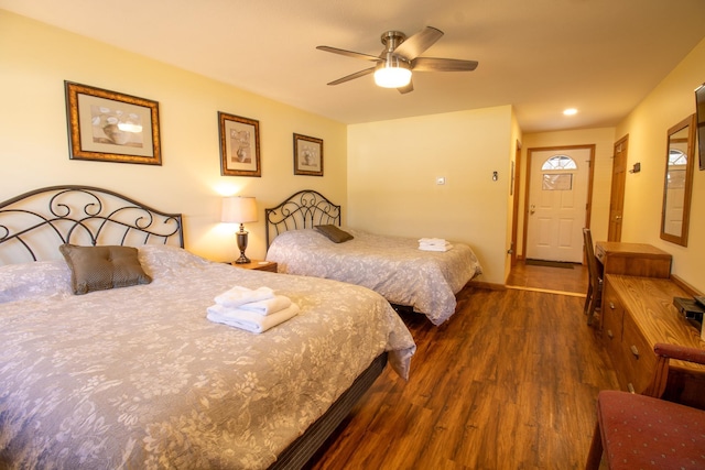 bedroom with baseboards, ceiling fan, and wood finished floors