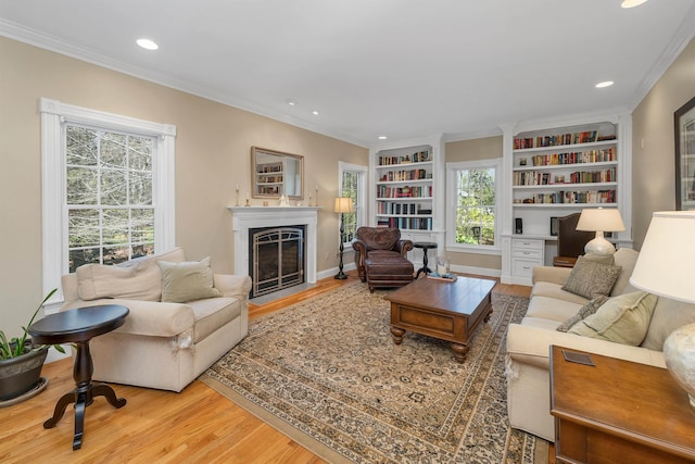 living room featuring crown molding, recessed lighting, a fireplace with flush hearth, and wood finished floors