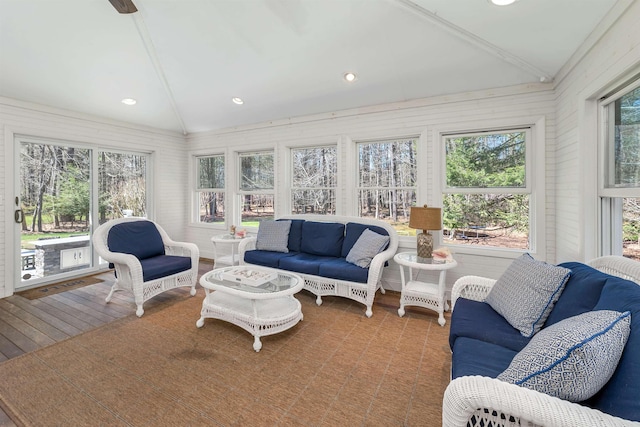 sunroom / solarium with recessed lighting, vaulted ceiling, wood finished floors, and an outdoor hangout area