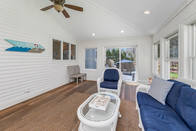 sunroom / solarium featuring a ceiling fan, wood finished floors, vaulted ceiling, and a deck