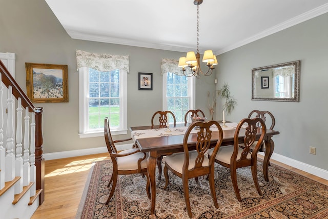 dining room featuring plenty of natural light, stairs, and a chandelier