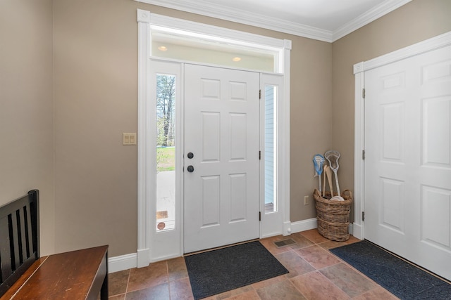 entryway with baseboards, visible vents, and ornamental molding