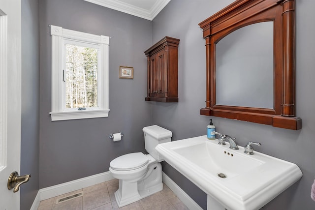 bathroom with visible vents, ornamental molding, toilet, baseboards, and a sink
