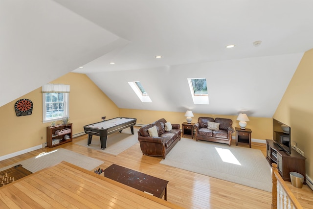 playroom with light wood-style floors, baseboards, vaulted ceiling with skylight, and recessed lighting