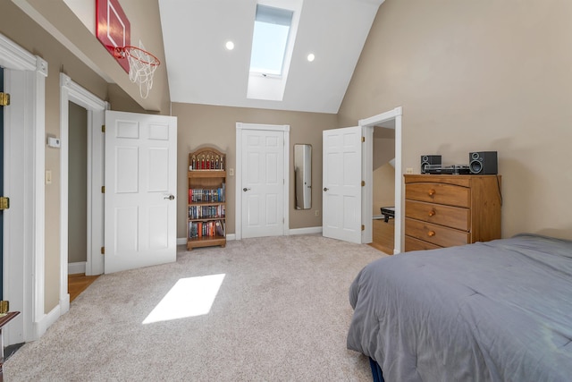 carpeted bedroom featuring baseboards, high vaulted ceiling, and a skylight