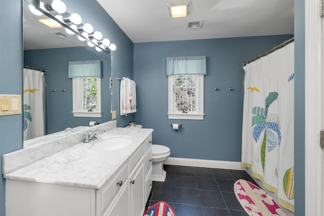 bathroom with baseboards, vanity, tile patterned floors, and visible vents