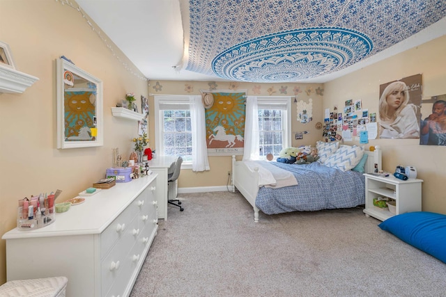 bedroom with baseboards and light carpet