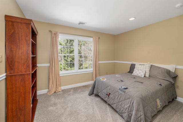 carpeted bedroom with baseboards and visible vents