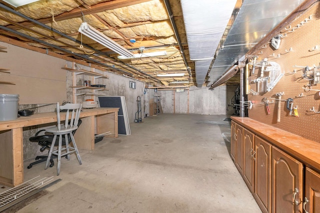unfinished below grade area featuring a workshop area