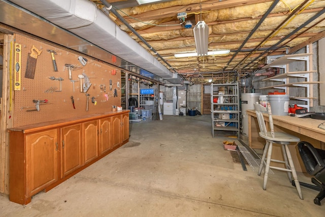 unfinished basement with a workshop area and gas water heater