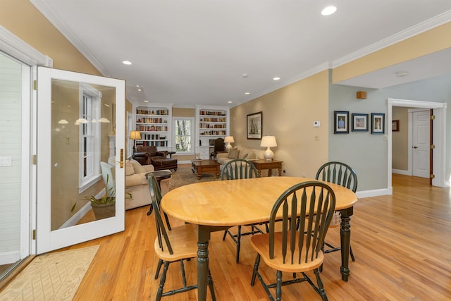 dining room with built in features, baseboards, light wood finished floors, ornamental molding, and recessed lighting