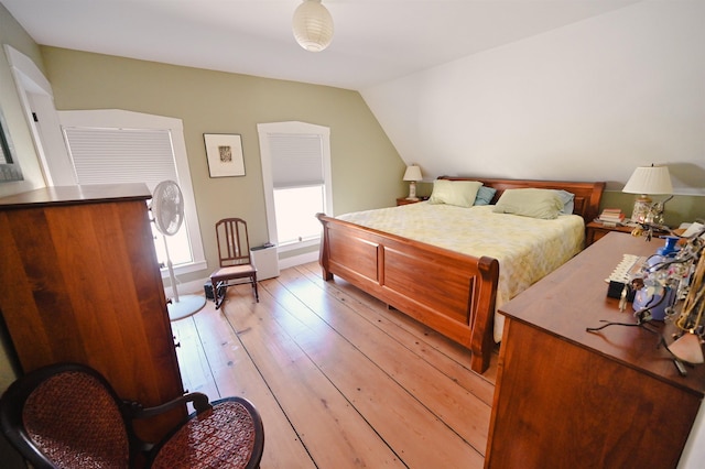 bedroom featuring vaulted ceiling and light wood-style flooring