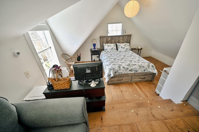 bedroom featuring lofted ceiling and hardwood / wood-style flooring