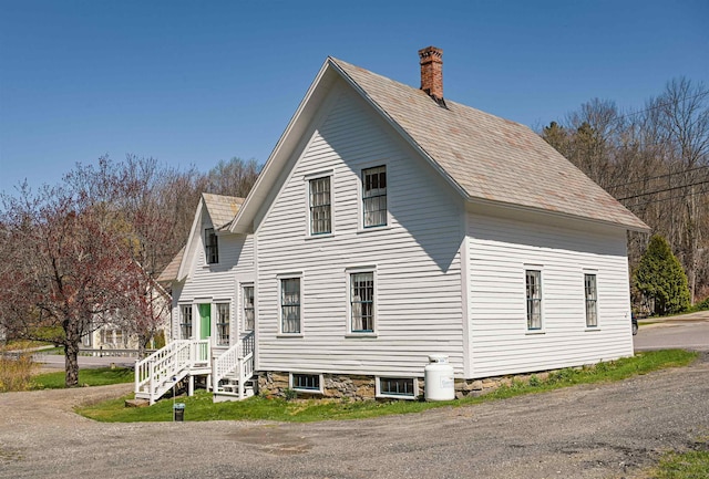 view of side of property featuring a chimney