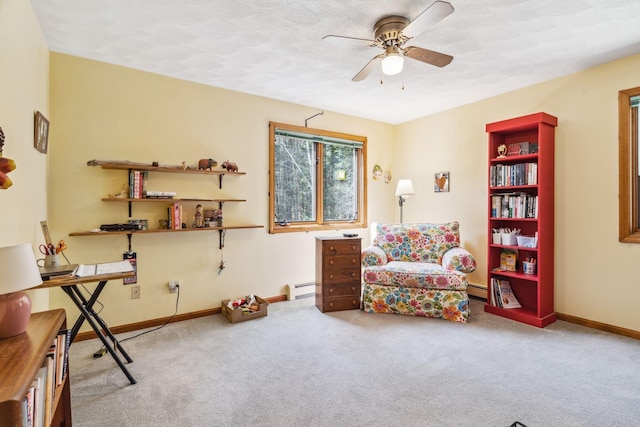 living area featuring carpet floors, a ceiling fan, baseboards, and baseboard heating