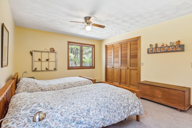 carpeted bedroom featuring a closet and a ceiling fan