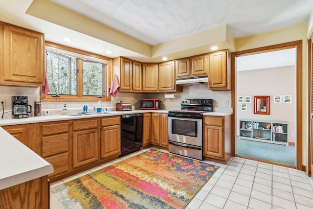 kitchen featuring stainless steel electric range oven, a sink, light countertops, under cabinet range hood, and black dishwasher