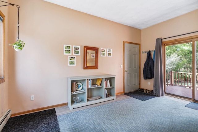 entryway with baseboards, a baseboard heating unit, and carpet floors