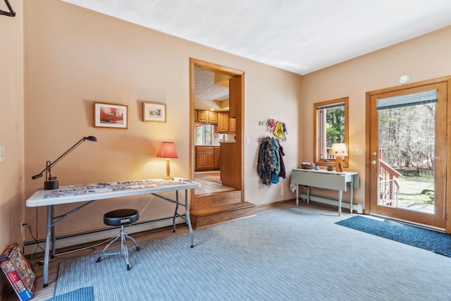 interior space featuring baseboards, a baseboard radiator, baseboard heating, and wood finished floors