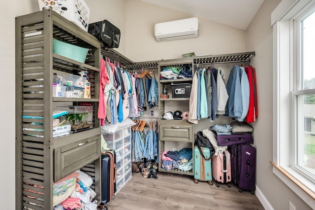 11 Post Rd, North Hampton, NH 03862 - spacious closet featuring a wall mounted AC, lofted ceiling, and wood finished floors