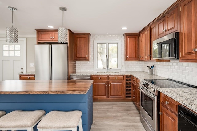 11 Post Rd, North Hampton, NH 03862 - kitchen with appliances with stainless steel finishes, a sink, wood counters, backsplash, and recessed lighting