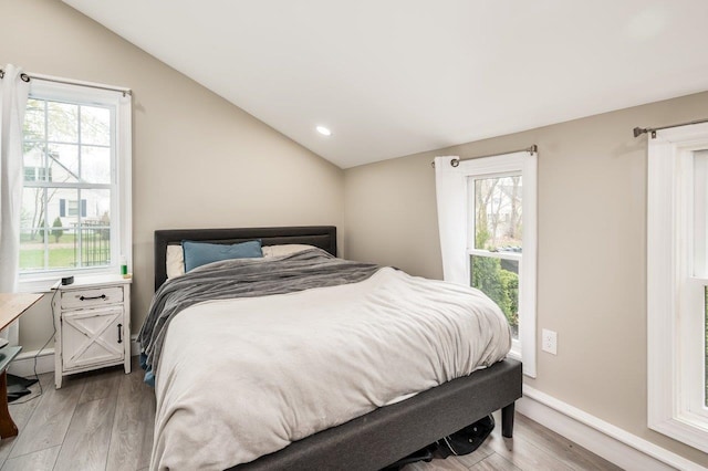 11 Post Rd, North Hampton, NH 03862 - bedroom featuring lofted ceiling, light wood-style floors, multiple windows, and baseboards