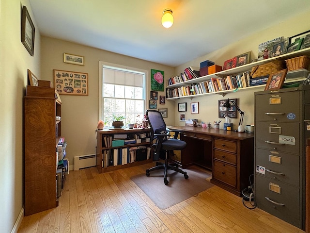 office area with light wood-style floors and a baseboard radiator