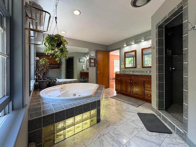 full bath with a tile shower, a tub with jets, vanity, marble finish floor, and recessed lighting