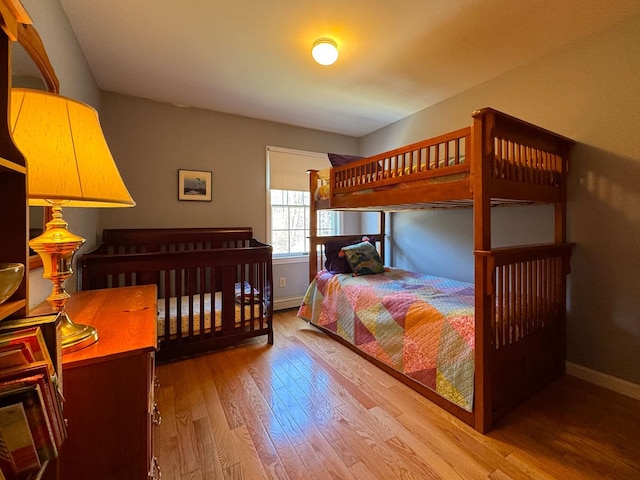 bedroom featuring baseboards and wood finished floors