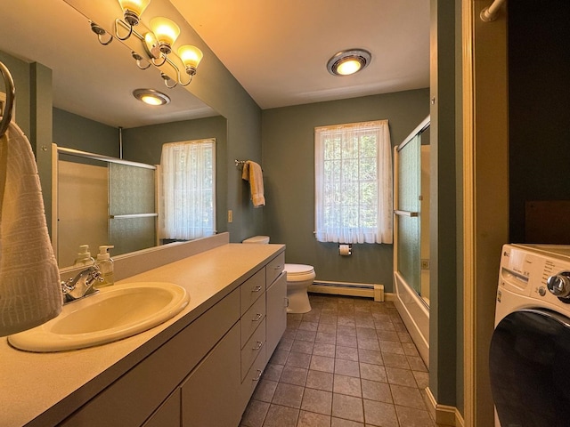 full bath with baseboards, a baseboard radiator, vanity, toilet, and washer / dryer