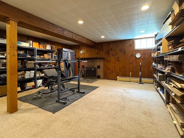 exercise area featuring carpet floors, wooden walls, and recessed lighting